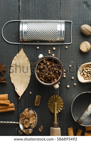 dessert spices and kitchen tools on black wooden table background