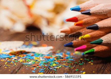 Pencil shavings and colored pencils on the wooden table