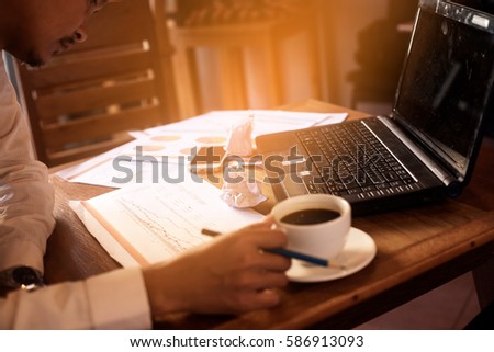 Business is clarifying about the margin target and year plan for his company on wooden working table.selected focus at a part of paper graph. Royalty-Free Stock Photo #586913093
