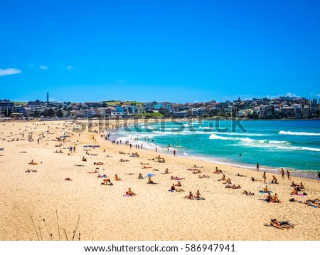 Beautiful Nature of Bondi Beach in Sydney, Australia. People enjoy swimming, surfing, and sunbathing. Royalty-Free Stock Photo #586947941
