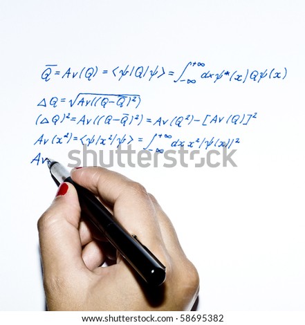 Young woman writing a physical formula with pen
