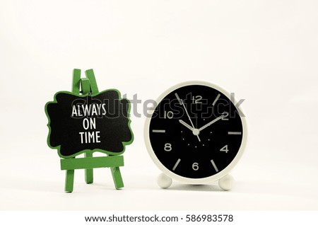 always on time word on mini wooden easel and near a analog clock