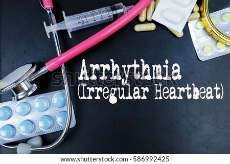 Arrhythmia (Irregular Heartbeat) word, medical term word with medical concepts in blackboard and medical equipment background