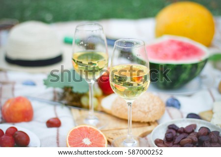 Glass of white wine on picnic table.  Dining People Concept.