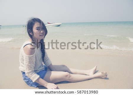 woman on the beach looking away at around