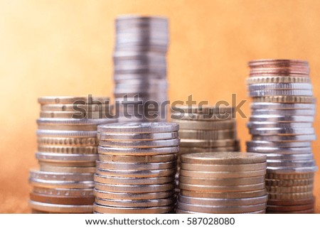 Stacks of coins on golden sparkle background. Financial concept