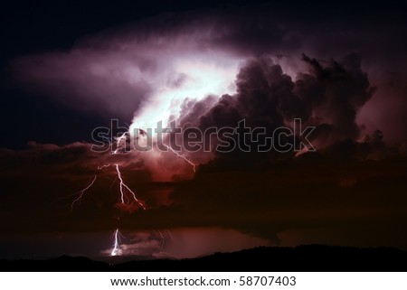 Lightening and storm over hills in the night Royalty-Free Stock Photo #58707403