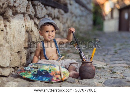 Little painter on the street in town
