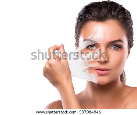 Young and beautiful woman with Purifying Mask on her face Royalty-Free Stock Photo #587084846