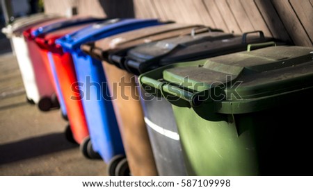 Row of Wheelie Bins for Recycling Waste Royalty-Free Stock Photo #587109998
