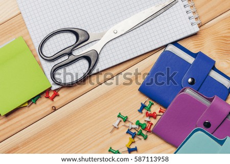 Stationery appliances, pens, notebooks, scissors, buttons, card holder.
