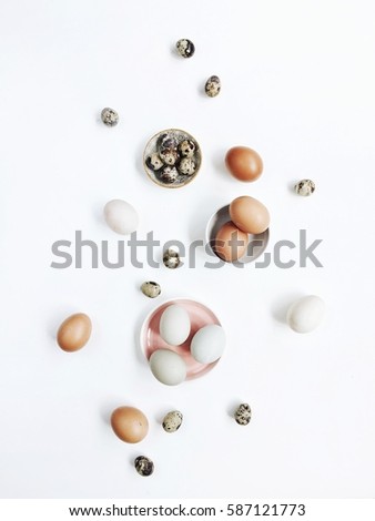White and brown Easter eggs and quail eggs on white background. Flat lay, top view. Traditional spring concept. Easter concept. Easter background
