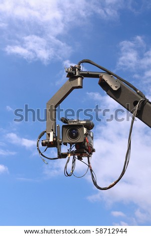 professional tv camera on a crane with blue sky