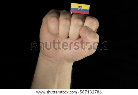 Man hand fist with Ecuadorean flag isolated on black background