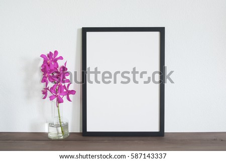 mock up frame photo  with orchid flowers on table