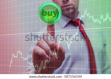 businessman makes pressing the green button with the image of success dollar symbol chart success in the rapidly growing profits / business success