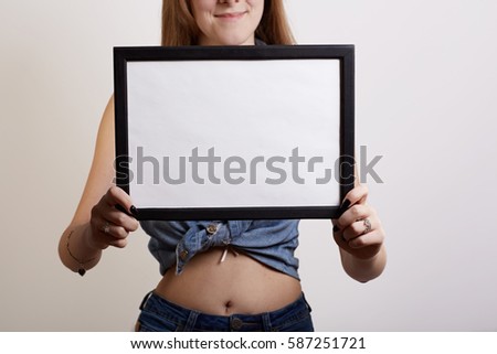 Girl student hold white blank board. female model.