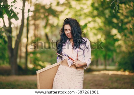 artist girl walks in the park. draws a picture. and resting