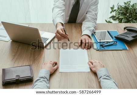 Businessman and customer having a business meeting in the office before signing a contract, point of view shot