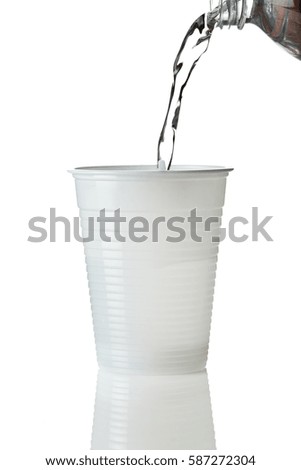pouring water into a plastic cup