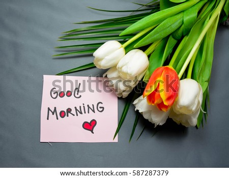 Bouquet of tulips and good morning text on a note