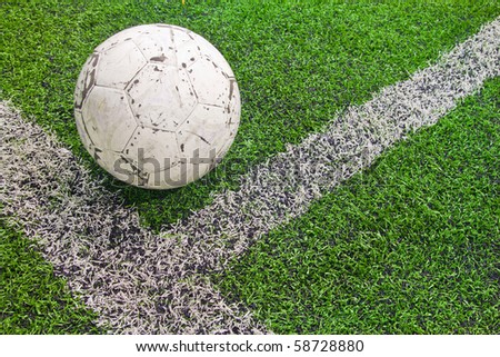 A white ball at the middle line of football field