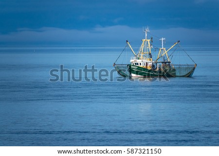 Shrimp boat on the North Sea, Germany. Royalty-Free Stock Photo #587321150