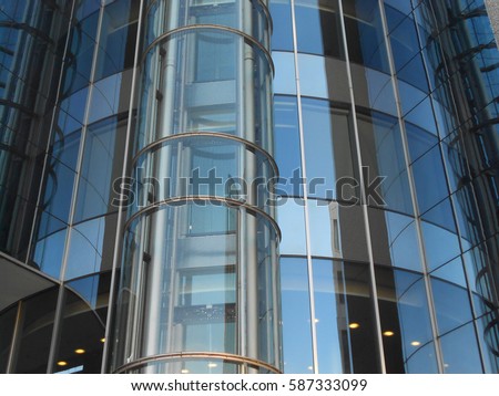  elevator at a modern building/elevator at the facade/glass facade        Royalty-Free Stock Photo #587333099