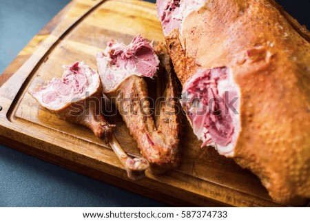 Smoked Duck Whole Sliced Wing Breast Selective Focus on Wooden Tray