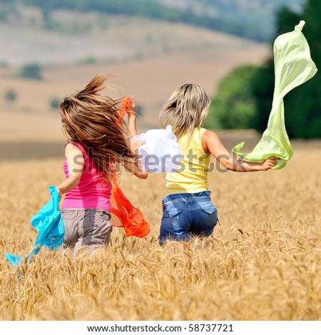 happy young women on field in summer