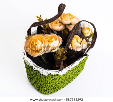 Green knitted decorative basket of flowers. Studio Photo
