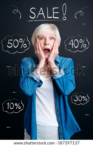 Surprised senior woman visiting a sale