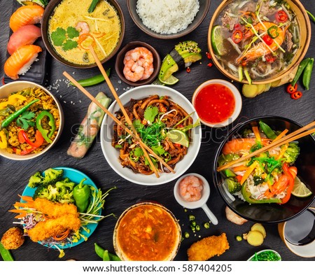 Asian food served on black stone, top view. Chinese and vietnamese cuisine set. Royalty-Free Stock Photo #587404205