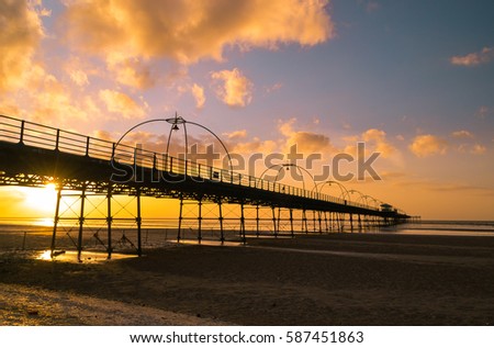 Sunset on the beach in Southport, England. Royalty-Free Stock Photo #587451863