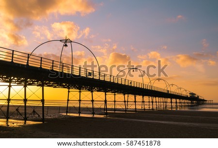 Sunset at the pier.  Southport, England. Royalty-Free Stock Photo #587451878