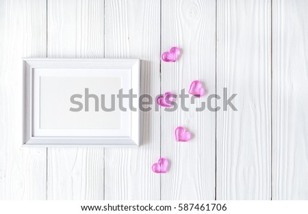 baby shower - blank picture frame on wooden background