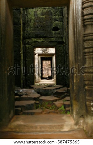 Shallow depth of field view through ancient stone doorways in Angkor Wat temple, Cambodia