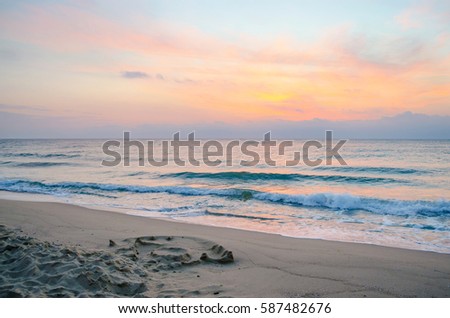 Sunset on the beach. Colorful dawn over the sea. Dramatic sky