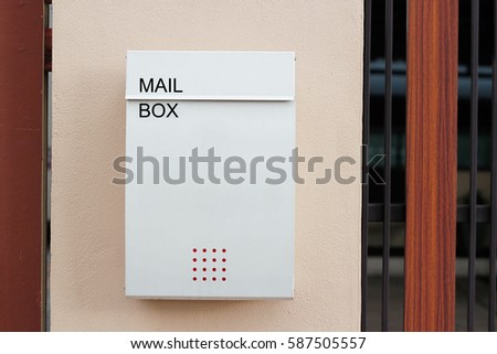 Modern mailbox on a wall fence