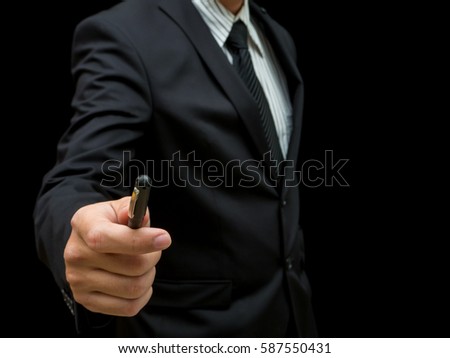 businessman pointing by pen on black background