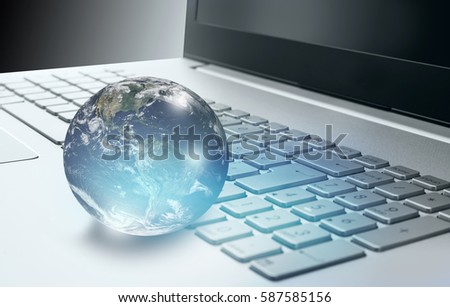 Glass globe on laptop keyboard "Elements of this image furnished by NASA "