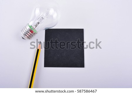 Blank black notepad, sharpener and pencil isolated on white background.