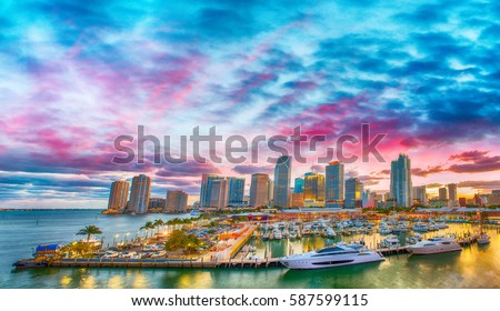 Magnificent dusk colors of Miami skyline, Florida. Panoramic sunset view. Royalty-Free Stock Photo #587599115