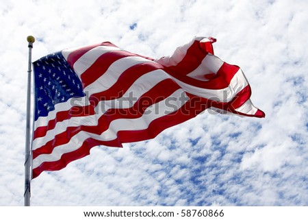United States flag waving in the wind with beautiful sky in background