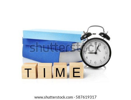 Cubes with alarm clock and stack of books on white background. Time concept