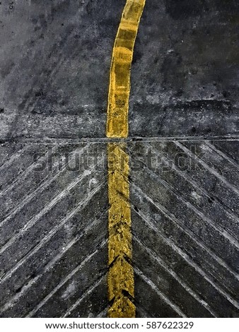 yellow line center and arrow sign concrete sidewalk for background