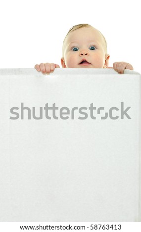 eight month baby holds on to the white box Royalty-Free Stock Photo #58763413