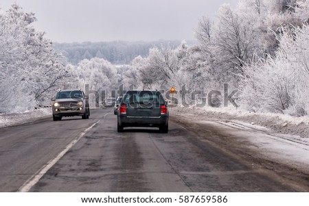 scenic veiw of empty road with snow covered landscape while snowing in winter season.