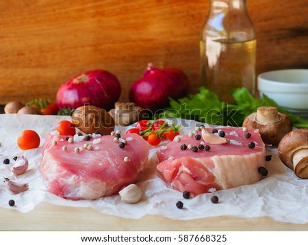 Raw pork chop steak prepare in kitchen with vegetable and spices for food and cooking concept.