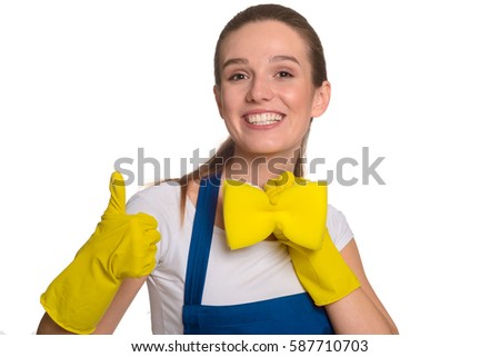 Good-looking woman making a bow-tie out of sponge. Wearing protective gloves and an apron, giving a thumbs-up. Happy cleaner having fun.